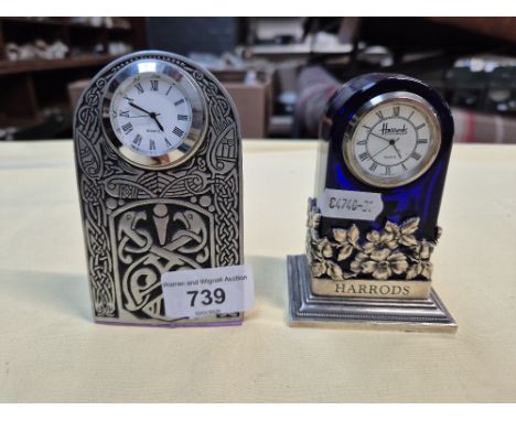 A Harrod's white metal and blue glass clock and a pewter clock with Celtic design. 