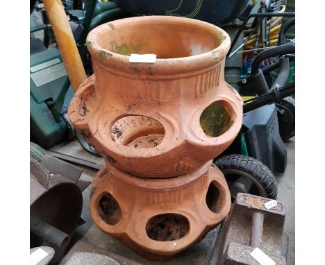 Two terracotta strawberry planters, a Singer model 66 lotus pattern hand crank sewing machine and a scythe.