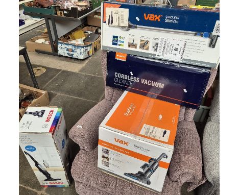 A group of 4 boxed vacuum cleaners comprising of a Vax dual power Pet Advance upright vacuum cleaner, a Vax cordless Slimvax 