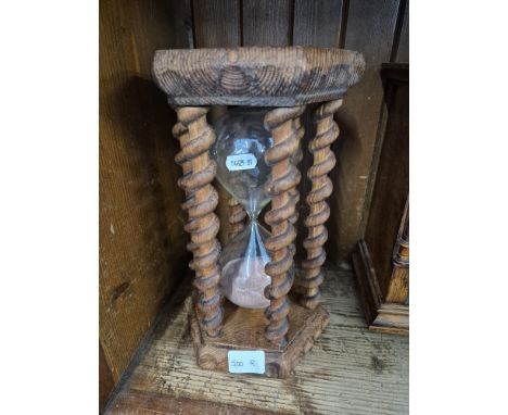 A ships half hour glass timer in carved pitch pine surround with twist supports. 
