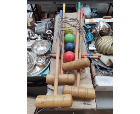 A boxed set of croquet mallets 