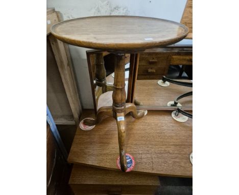 A 19th century elm tripod table, height 61cm.