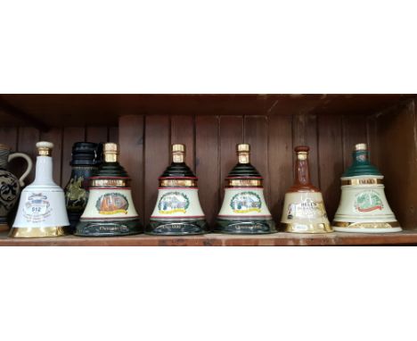 6 ceramic Bells whisky decanters by Wade, a miniature QE2 single malt jug (sealed), a Marzi &amp; Remy German stoneware pitch