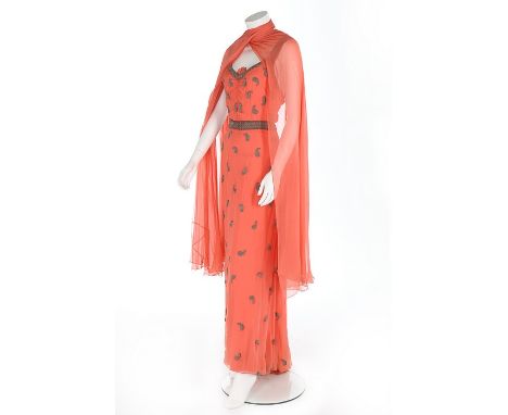 A beaded salmon-pink chiffon evening gown, late 1930s, with overall silver seed-bead paisley motifs, ruched gathers to bust, 