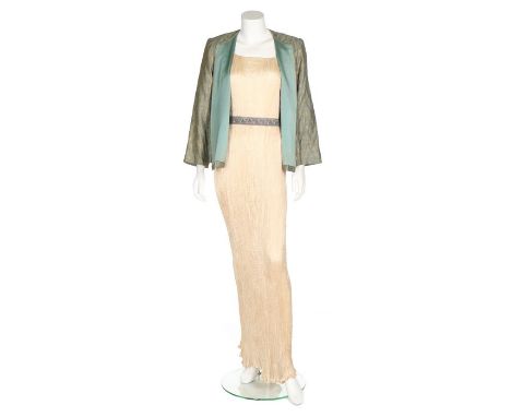A Mariano Fortuny ivory silk Delphos gown, 1920-30, un-labelled, with short curving sleeves laced with Murano brown and white