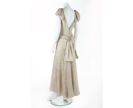 A rare Jenny couture gold lamé evening gown, circa 1936, labelled and numbered 5617, with plunging low back, draped bands to 