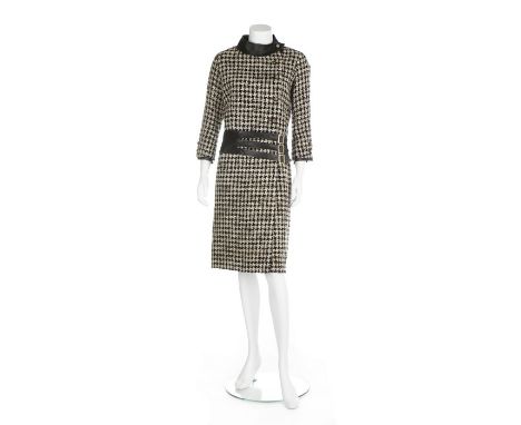 A Chanel couture hound's tooth checked tweed and kid leather suit, 1965, labelled but not numbered, the box-cut jacket with b