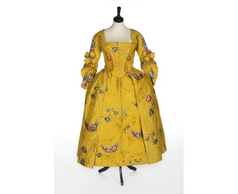 A fine brilliant yellow Spitalfields brocaded silk robe à l'Anglaise, circa 1750, woven with brightly coloured large scale or