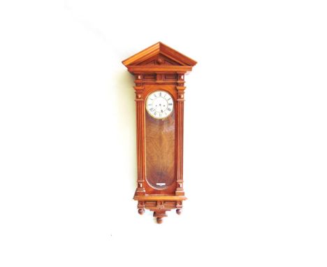 A CONTINENTAL VIENNA REGULATOR WALL CLOCK,  in architectural walnut case, enamel dial with Roman numerals, the twin train wei
