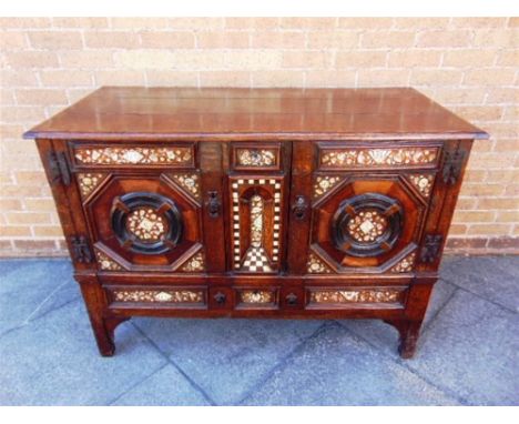 AN INTERESTING OAK SIDE CABINET  profusely inlaid with bone, mother-of-pearl and composition, central trompe l'oeil arcaded p