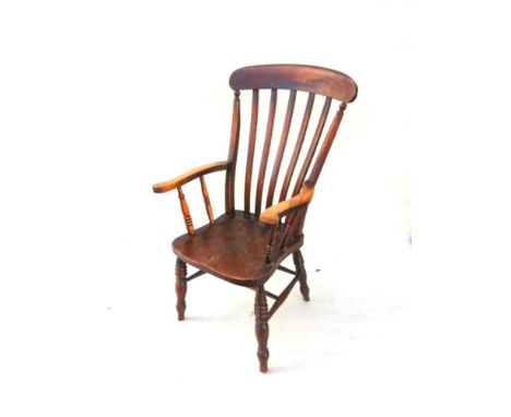 A COMB BACK WINDSOR ARMCHAIR,  on turned supports with stretchers, the elm seat 49cm wide 49cm deep, 116cm high overall