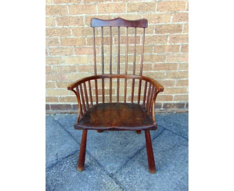 AN 18TH CENTURY COMB BACK WINDSOR ARMCHAIR,  the dished elm seat 45cm wide 38cm deep, 86cm high overall 