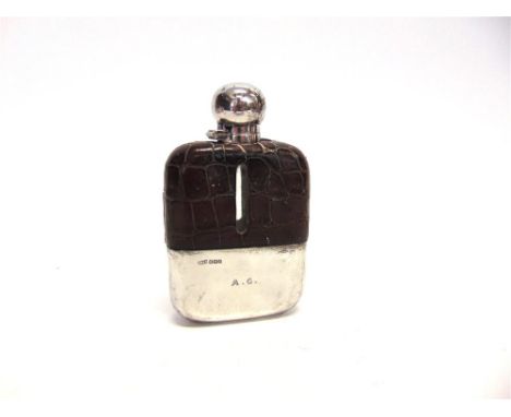 A SILVER AND CROCODILE SKIN MOUNTED GLASS HIP FLASK by James Dixon & Sons, Sheffield 1918, with bayonet captive top, pull off