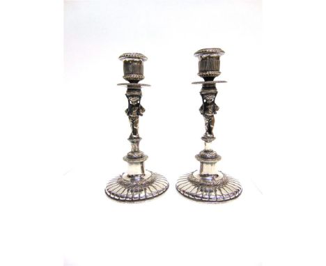 A PAIR OF VICTORIAN ELECTROPLATED FIGURAL CANDLESTICKS by Elkington Mason & Co, the cherub is stand to a socle base, bearing 