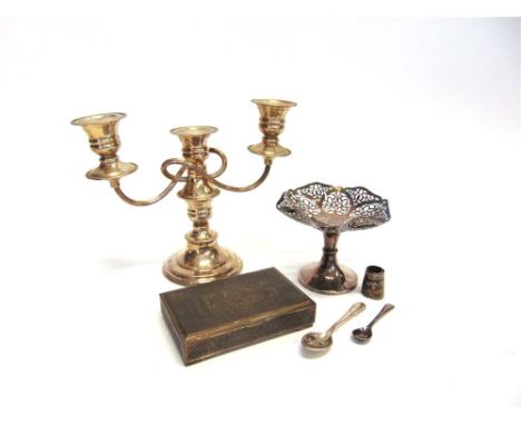 AN EASTERN EMBOSSED CIGARETTE BOX with control marks; a plated three light candelabra; a pedestal bon bon dish and two spoons