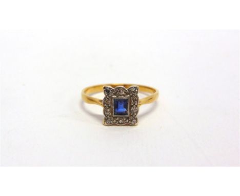 A SAPPHIRE AND DIAMOND PANEL RING the rectangular cut stone enclosed by ten single cut diamonds, finger size Q, 2.9g gross