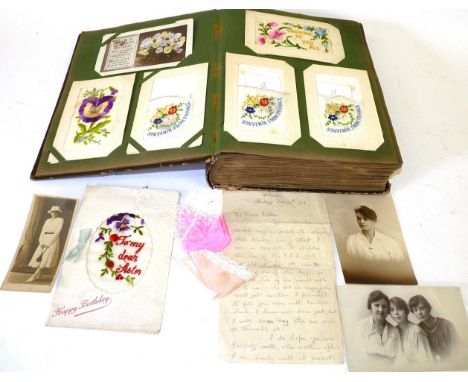 An Early 20th Century Postcard Album, containing many First World War battlefield scenes, portrait photographs of servicemen,