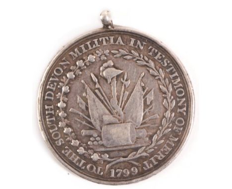 A South Devon Militia Medal of Merit 1799, the obverse with a trophy of arms enclosed by a wreath, with circumscription, 'TO 