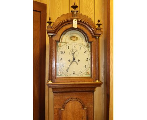 An oak cased longcase clock. Early 19th Century clock striking on a bell with an 8 day movement, arched painted face, separat