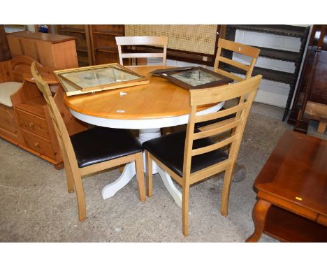 A circular pedestal kitchen table and four ladder back chairs
