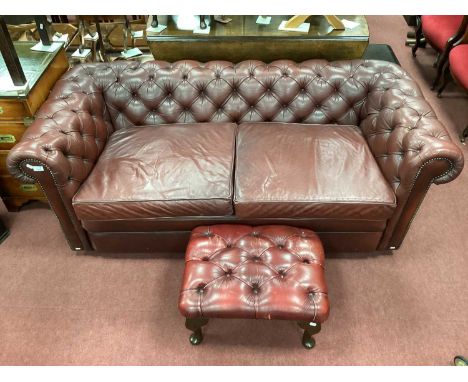 Ox Blood Two Seater Chesterfield Settee, with stud decoration, 180cm wide, together with a stool (2).Used condition. Some mar