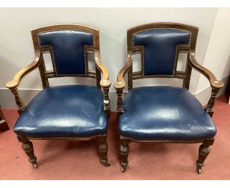 Early XX Century Oak Blue Leather Open Armchairs, with leather panel back, leather seat, shaped arms on turned legs.