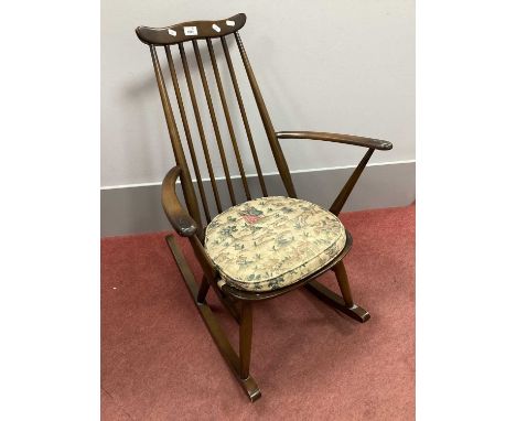 Dark Ercol Rocking Chair, (bearing label) with a shaped top rail, spindle supports, on rockers.