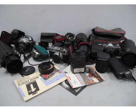 Cameras; A Quantity Of Cameras and Camera Lenses. To Include Canon AE-1 With F/1.8 50mm Lense In Case, Canon Ixus X1 With 23m