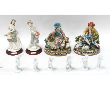 A Pair of Capodimonte Figurines, by Cortese, a boy with rabbits, a girl with chickens on an oval base, a pair of Auro Belcari