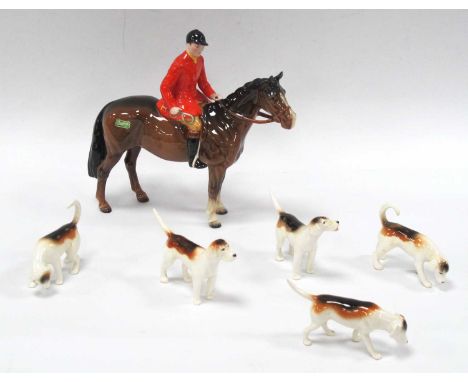 A Beswick Pottery Huntsman wearing red overcoat and black helmet on brown horse, marked to base and sticker to side, approx. 