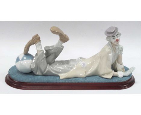 Lladro Pottery Figure of Reclining Clown with a Ball 36.5cm long, together with oval stand.