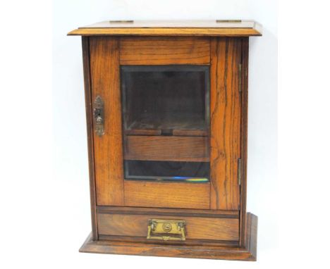 Early XX Century Oak Smokers Cabinet, with a glazed door, internal drawer, pipe stand, and single drawer, on a moulded base, 