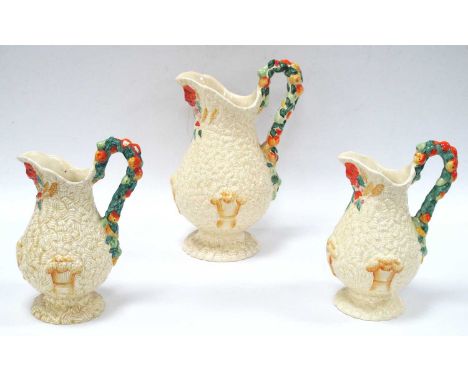 Three Clarice Cliff "Celtic Harvest" Pattern Graduated Jugs, the tallest 28cm high.