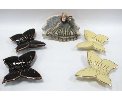 Jerna Holland 217 Figurine, of a girl sat on a sofa, together with butterfly wall pockets:- One Tray.