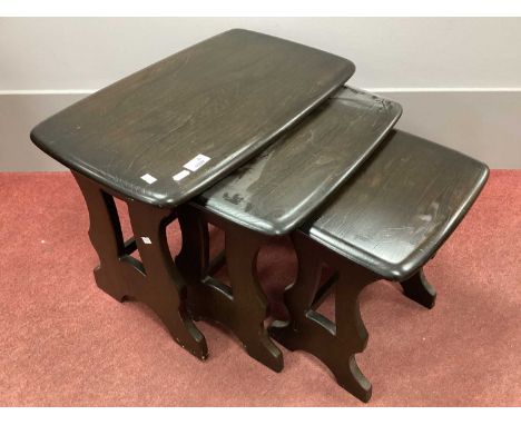 Dark Ercol Nest of Tables, with shaped ends, (with label) 58cm wide.