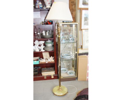 A brass and onyx standard lamp, on circular base