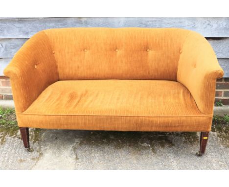 An Edwardian two-seat settee, upholstered in an old gold cord, on square taper supports, 50” wide Condition: Good overall con