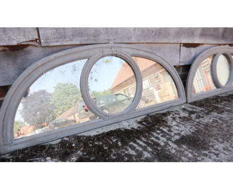A pair of grey painted lunette mirrors with central circular panel, 51 1/2" wide x 19" high (Please note this lot is also sub