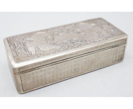 A white metal rectangular snuffbox with engine turned, engraved decoration and gilt interior, indistinct marks to lid, 3 1/4"