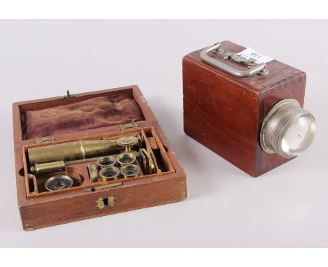 A mahogany cased magnifying set and a signalling light