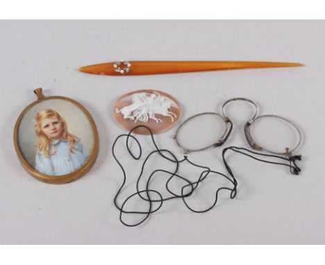 A carved shell cameo, winged woman with horses, a horn hairpin with seed pearl decoration, miniature portrait of a young girl