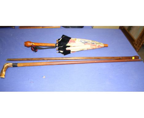 A silver collared walking stick with antler handle, a parasol and another walking stick