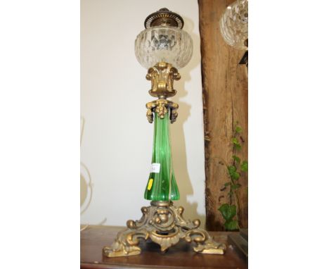 A Victorian oil lamp with green glass column and clear glass reservoir (now converted to electricity)Condition:No apparent da