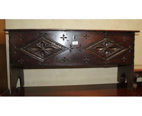 A chip carved planked coffer, on panel end supports, 38" wide