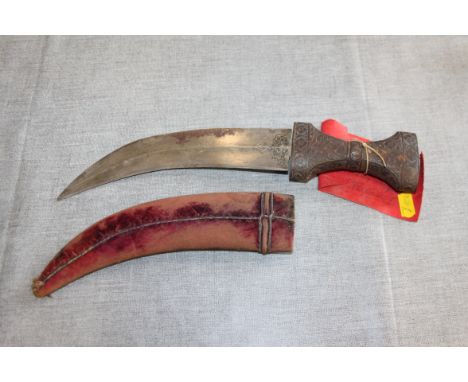A mid 19th century jambiya with wooden and fabric scabbard and metal floral decorated handle, 13" overall