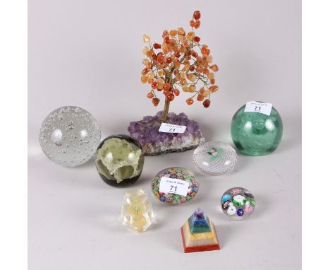 An amethyst and carnelian tree, 7 1/2" high, seven paperweights and a pyramid-shaped semi-precious stone paperweightCondition