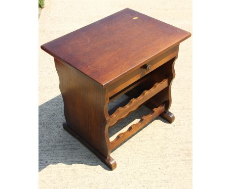 An oak "wine table" to hold twenty bottles, on panel end supports, 24" long x 18" wide x 23 1/2" high