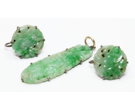 A carved jadeite jade pendant and matching earrings, pendant length 42mm, earring diameter 17mm. Condition - good, general we