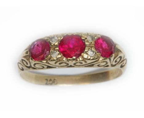 A synthetic ruby and colourless stone ring, scroll setting, marked '9ct', gross weight 2.7g, size Q.  