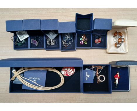 A collection of Swarovski jewellery comprising six rings and two pendant necklaces, together with a vintage hunter brooch and